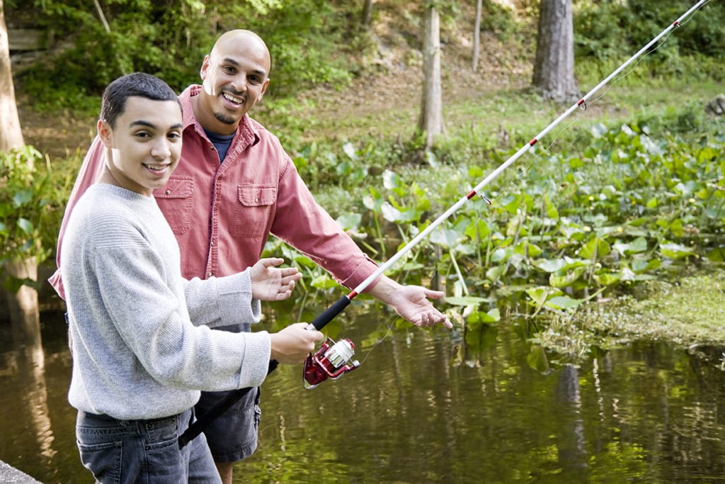 Fishing wilderness therapy with young teen and older man