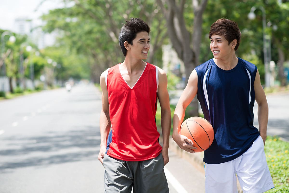 Christian boarding school student talking and walking with friend