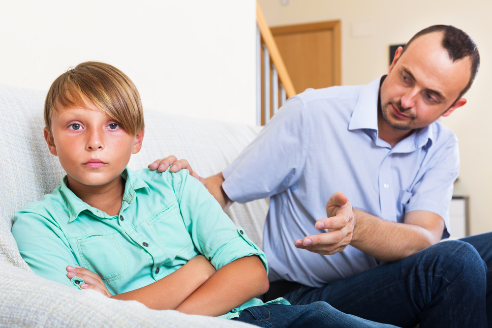 Parent talking with their child in their home