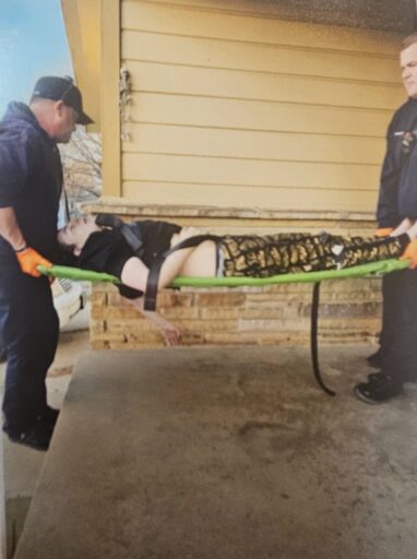 Lucas being taken to hospital on stretcher