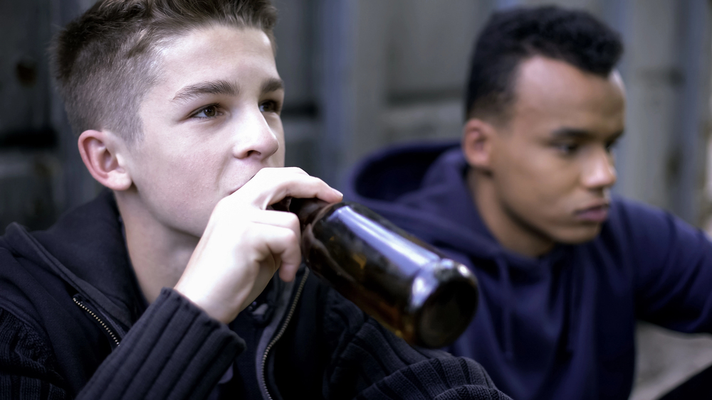 two underage teen boys drinking alcohol